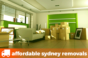 a room with a lounge, picture frame and removalist boxes waiting to be collected by a removalist